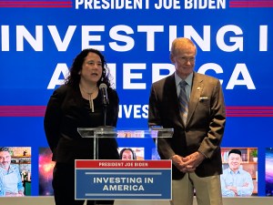 Small Business Administrator Isabella Casillas Guzman (left) and NASA Administrator Bill Nelson (right) are pictured in front of a sign reading "Investing in America" on July 18, 2023 at NASA's headquarters in Washington.