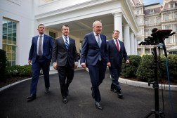 Sen. Martin Heinrich, D-N.M.; Sen. Todd Young, R-Ind.; Senate Majority Leader Charles Schumer, D-N.Y.; and Sen. Mike Rounds, R-S.D., are pictured walking out of the White House. The Eisenhower Executive Office Building is visible in the background.