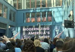 Man in suit on stage in front of an audience