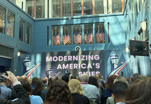 Man in suit on stage in front of an audience