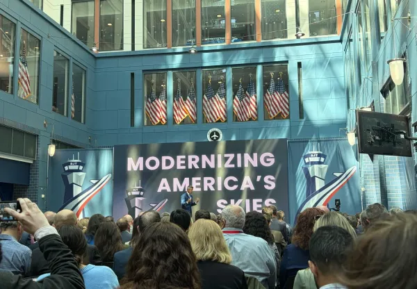 Man in suit on stage in front of an audience
