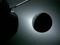 The Moon appears dark in the picture as white sunlight leaks out around its edges. A portion of the Orion spaceship, also in shadow, is visible on the left of the image.