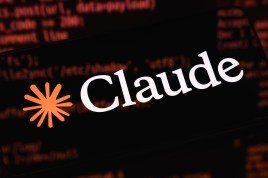 The image shows the Claude logo on a black screen. The logo is a star-like burst of orange followed by the word "Claude" in white text. Code appears reflected on the surface of the screen.