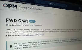 The photo shows photo of Federal Workforce Data Chat (FWD Chat) open on a computer screen. The banner across the top has the OPM logo and below that, the page reads "FWD Chat Beta."