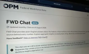 The photo shows photo of Federal Workforce Data Chat (FWD Chat) open on a computer screen. The banner across the top has the OPM logo and below that, the page reads "FWD Chat Beta."